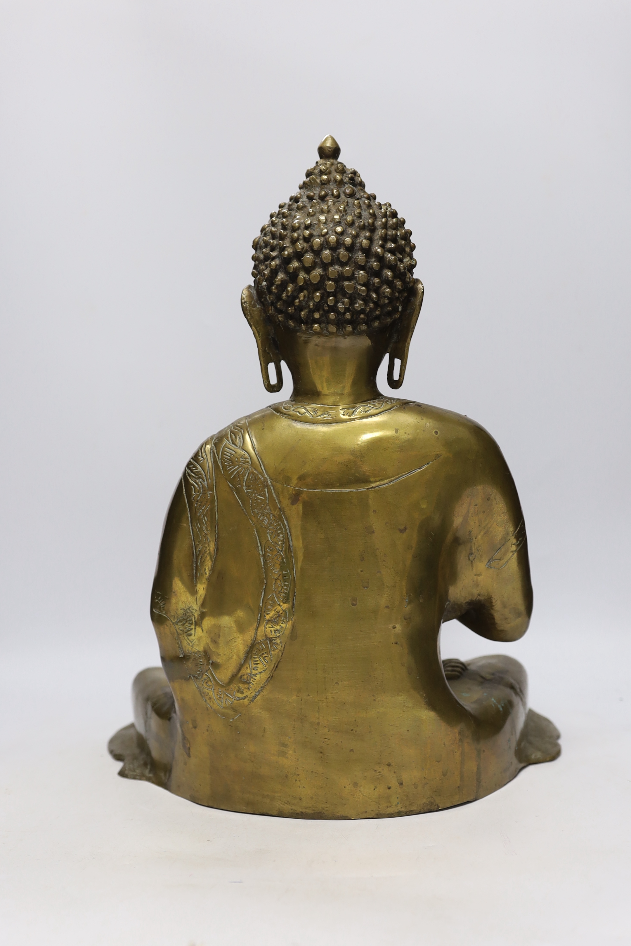 A Chinese or South East Asian bronze figure of seated buddha, 42cm high